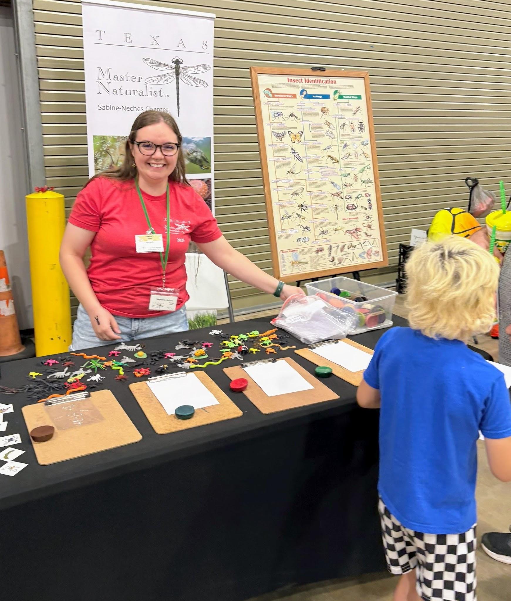 Volunteer sharing a nature activity with a child at Champions for Nature