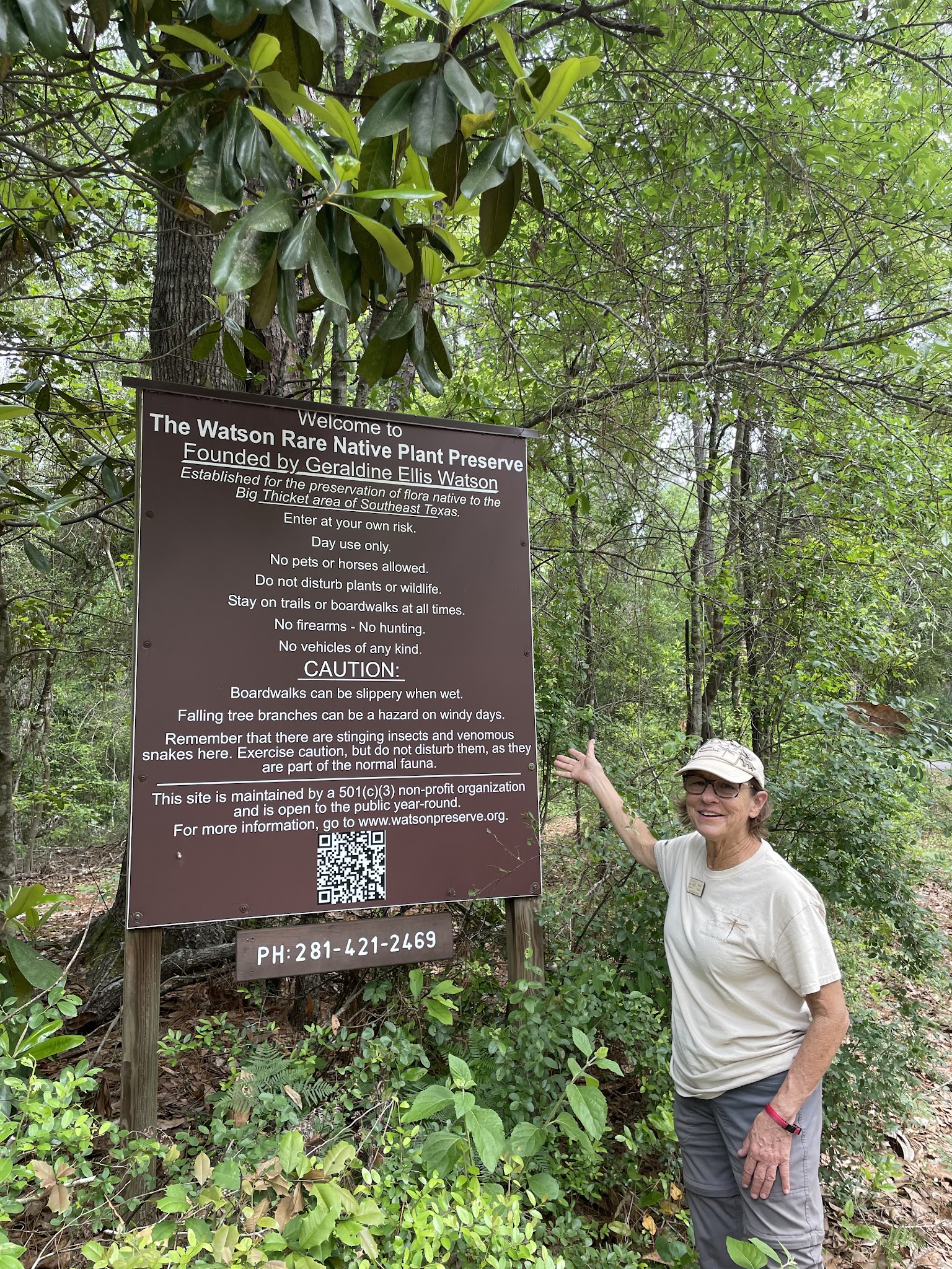 Guide standing beside the Watson Rare Native Plant Preserve sign